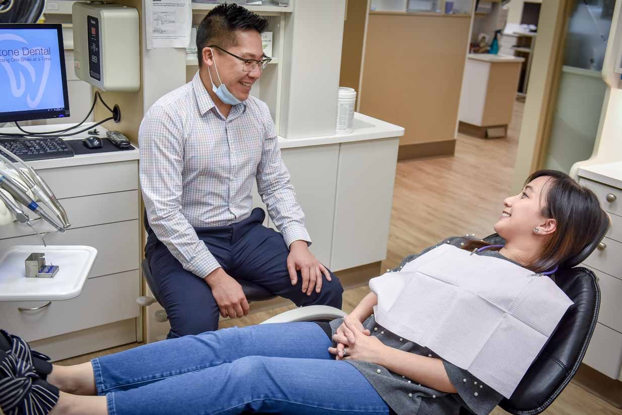 Sandstone Dental | North Calgary Dentist | Dr. Chris Lan Chatting With Patient