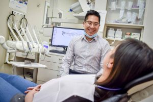 Sandstone Dental | North Calgary Dentist | Dr. Chris Lan Consulting with Patient