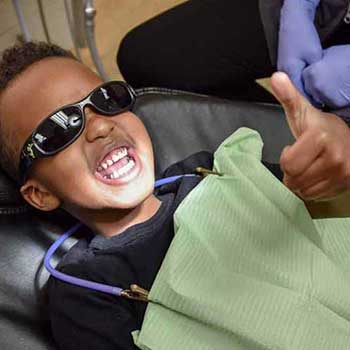 Sandstone Dental | North Calgary Dentist | Child Patient Giving Thumbs Up